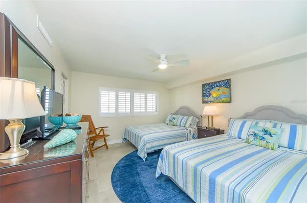 a bedroom with two beds and a couch