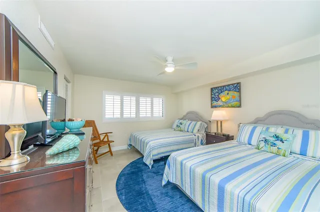 a bedroom with two beds and a couch