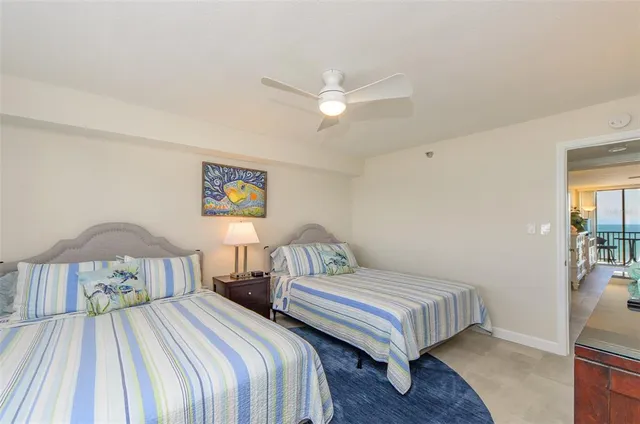 a bedroom with two beds and a table