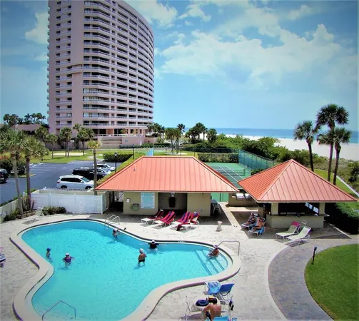 an outdoor space with pool and furniture