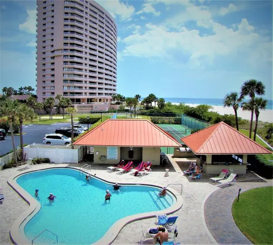 an outdoor space with pool and furniture