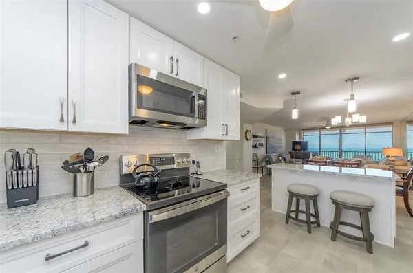 a kitchen that has a lot of cabinets in it and appliances
