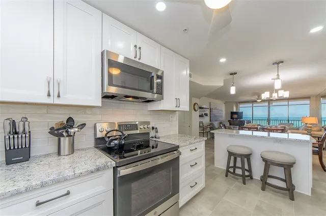 a kitchen that has a lot of cabinets in it and appliances