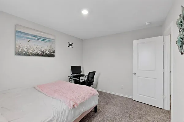 a bedroom with a bed and chair