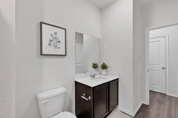 a bathroom with a sink toilet and vanity