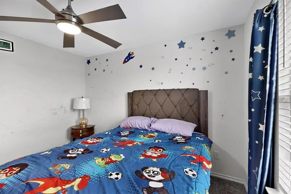 a bedroom with a bed and a dresser in it