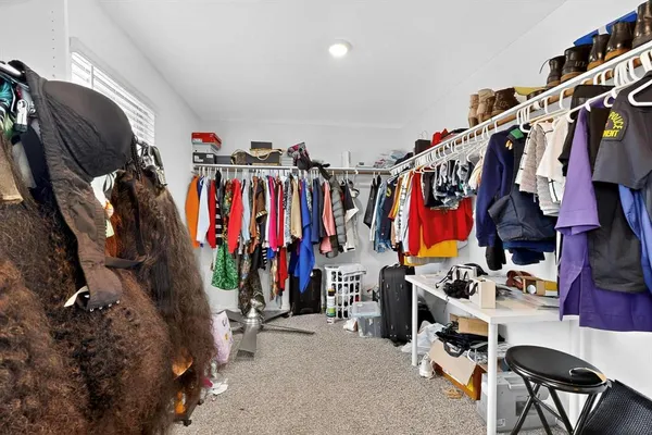 a view of walk in closet with clothes