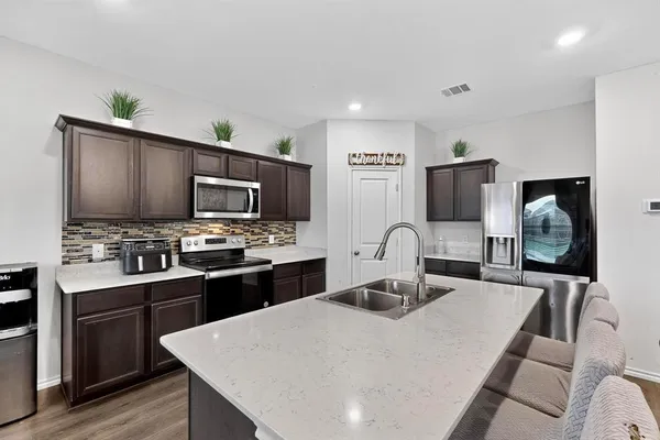 a living room with furniture a flat screen tv and a large window
