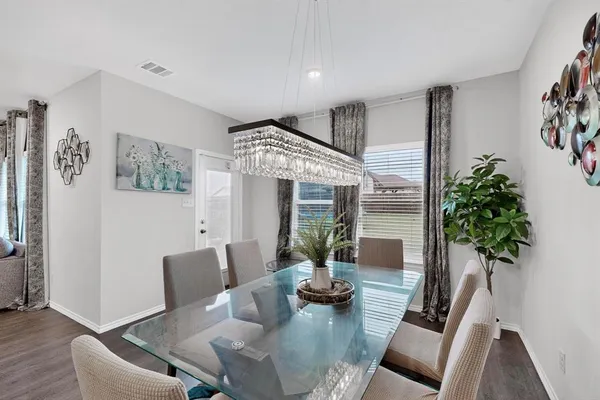 a living room with furniture and potted plant