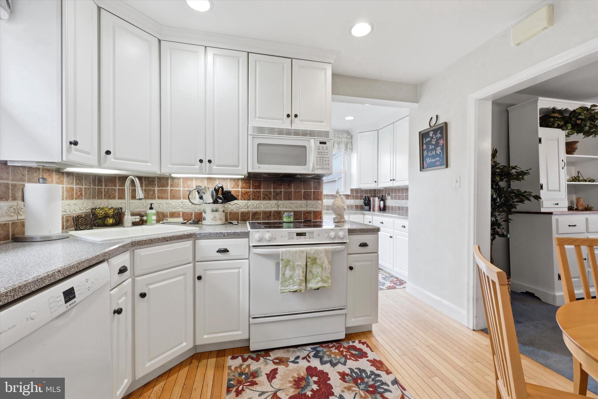 148 Sycamore Road Havertown, PA 19083 - Photo 13 of 29 a kitchen with granite countertop white cabinets and white appliances