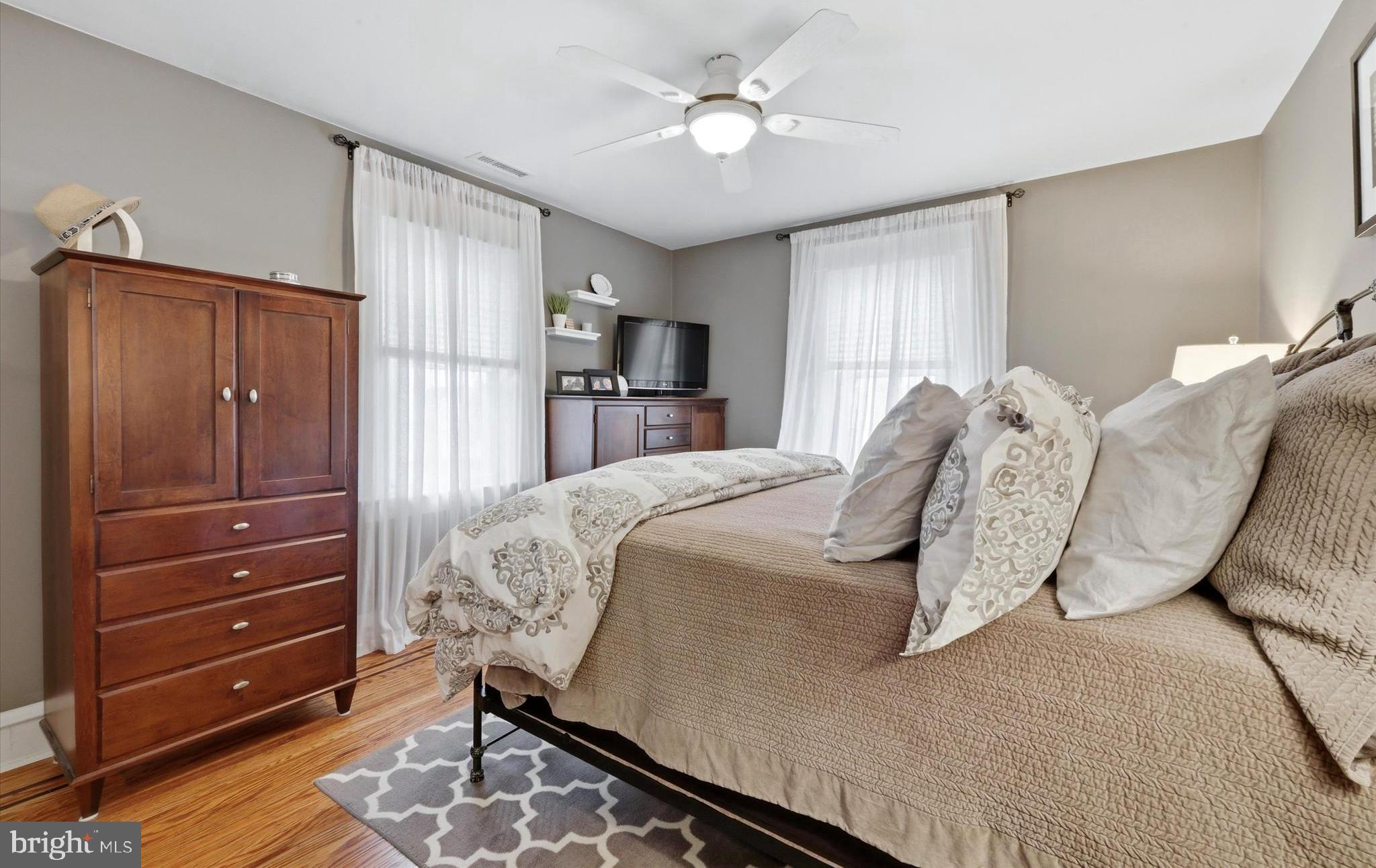 148 Sycamore Road Havertown, PA 19083 - Photo 15 of 29 a bedroom with a bed and a chandelier