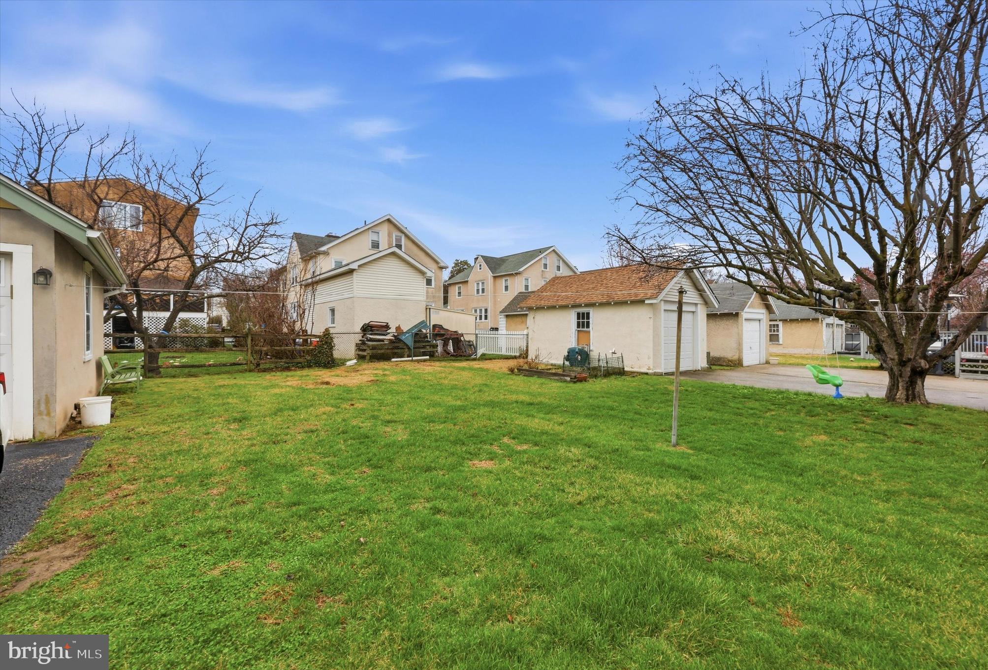 148 Sycamore Road Havertown, PA 19083 - Photo 3 of 29 a view of a white house in front of a big yard with large trees