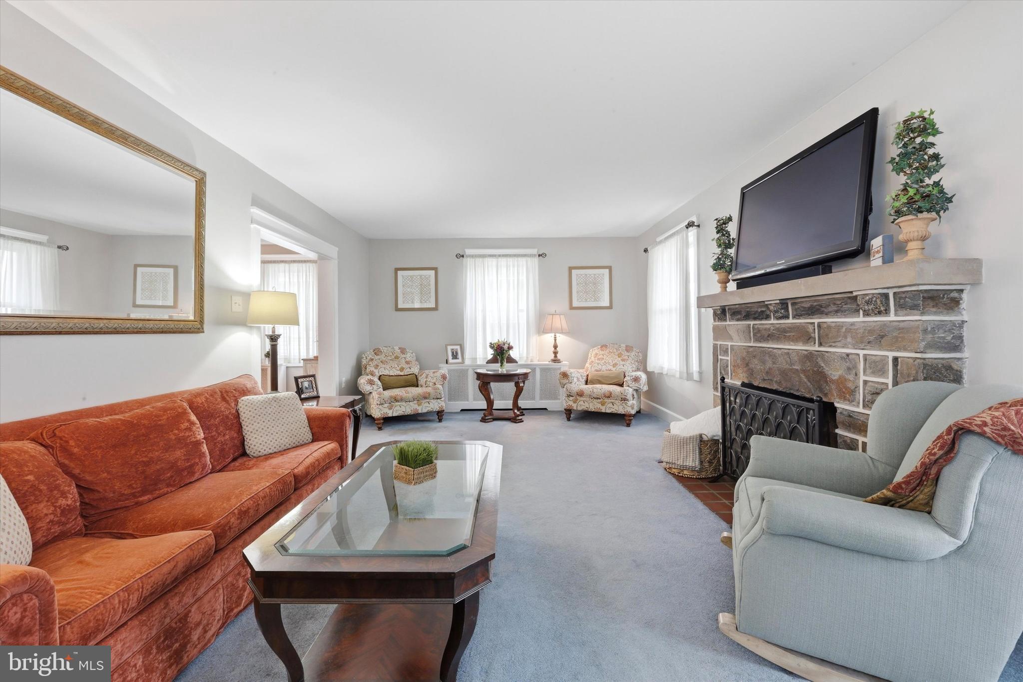 148 Sycamore Road Havertown, PA 19083 - Photo 6 of 29 a living room with furniture a fireplace and a flat screen tv