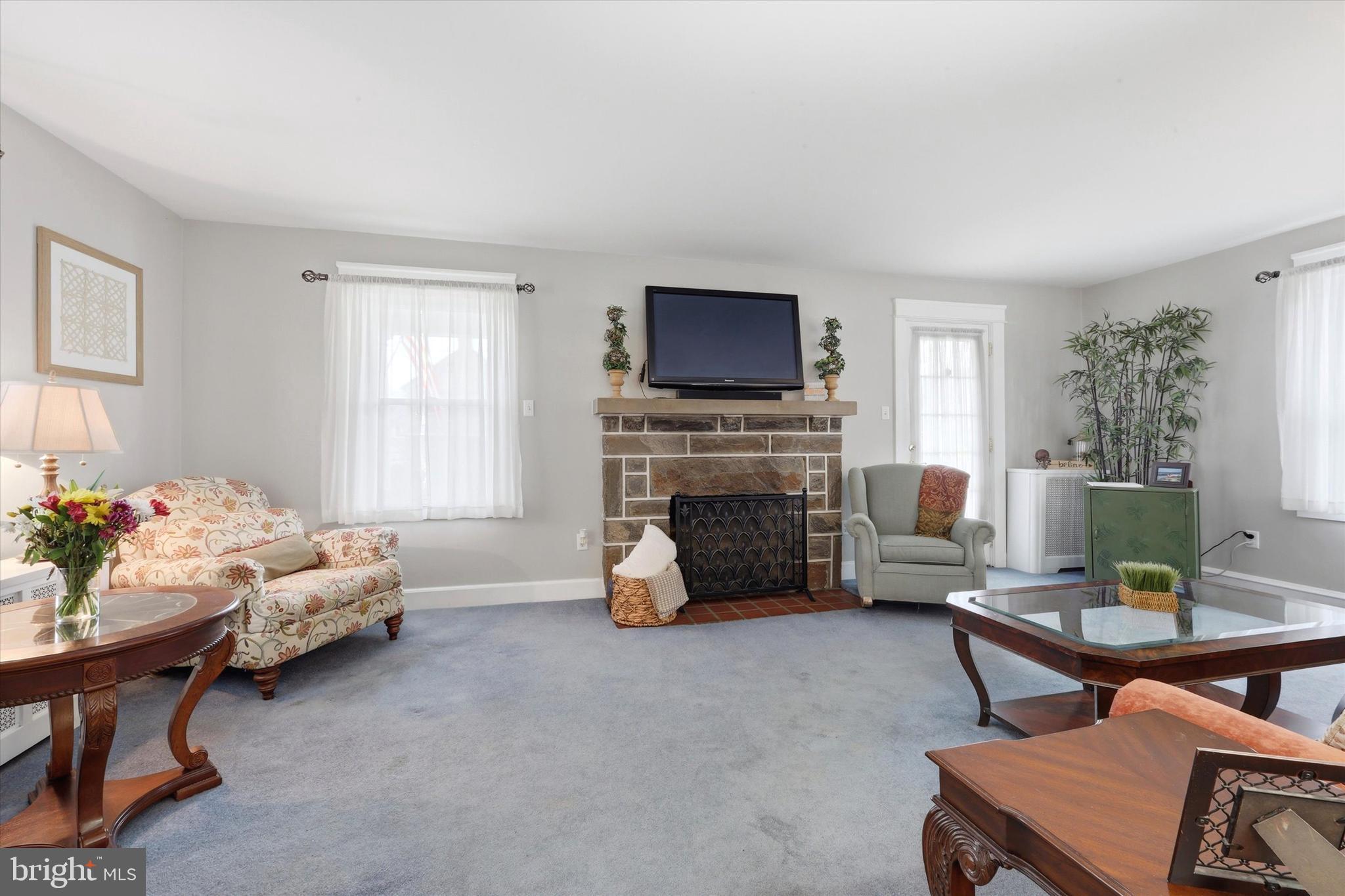 148 Sycamore Road Havertown, PA 19083 - Photo 7 of 29 a living room with furniture a fireplace and a flat screen tv