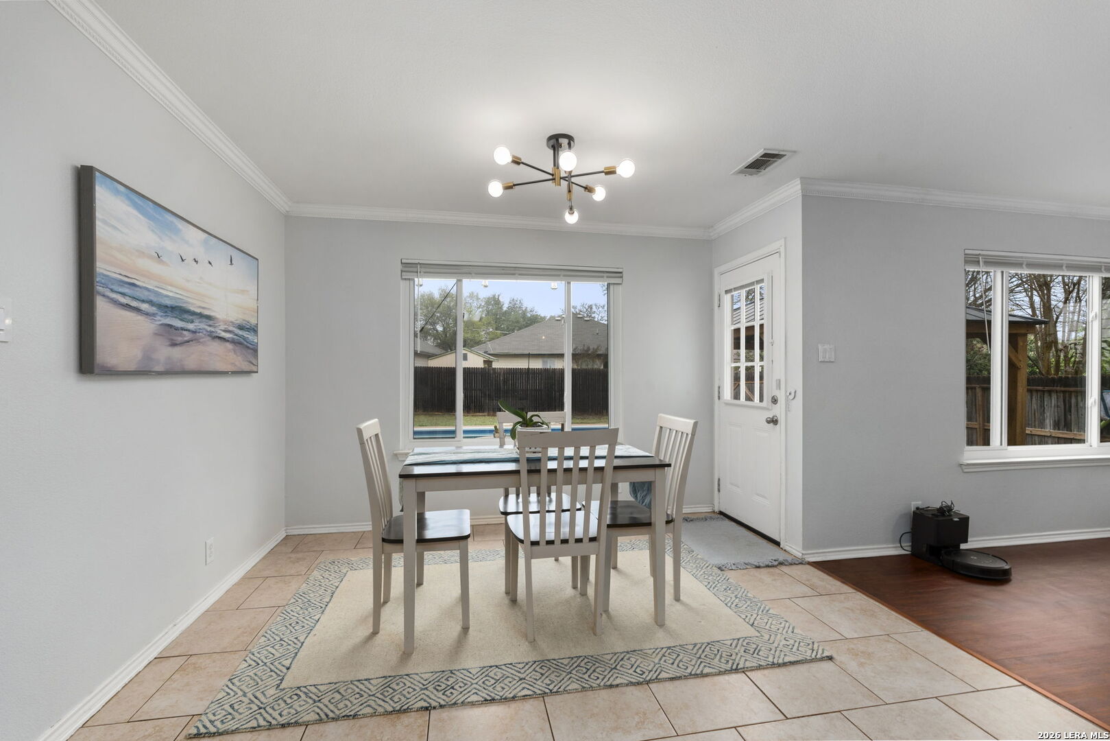 11911 Ghost Bridge Helotes, TX 78023 - Photo 13 of 47 a dining room with wooden floor and a window