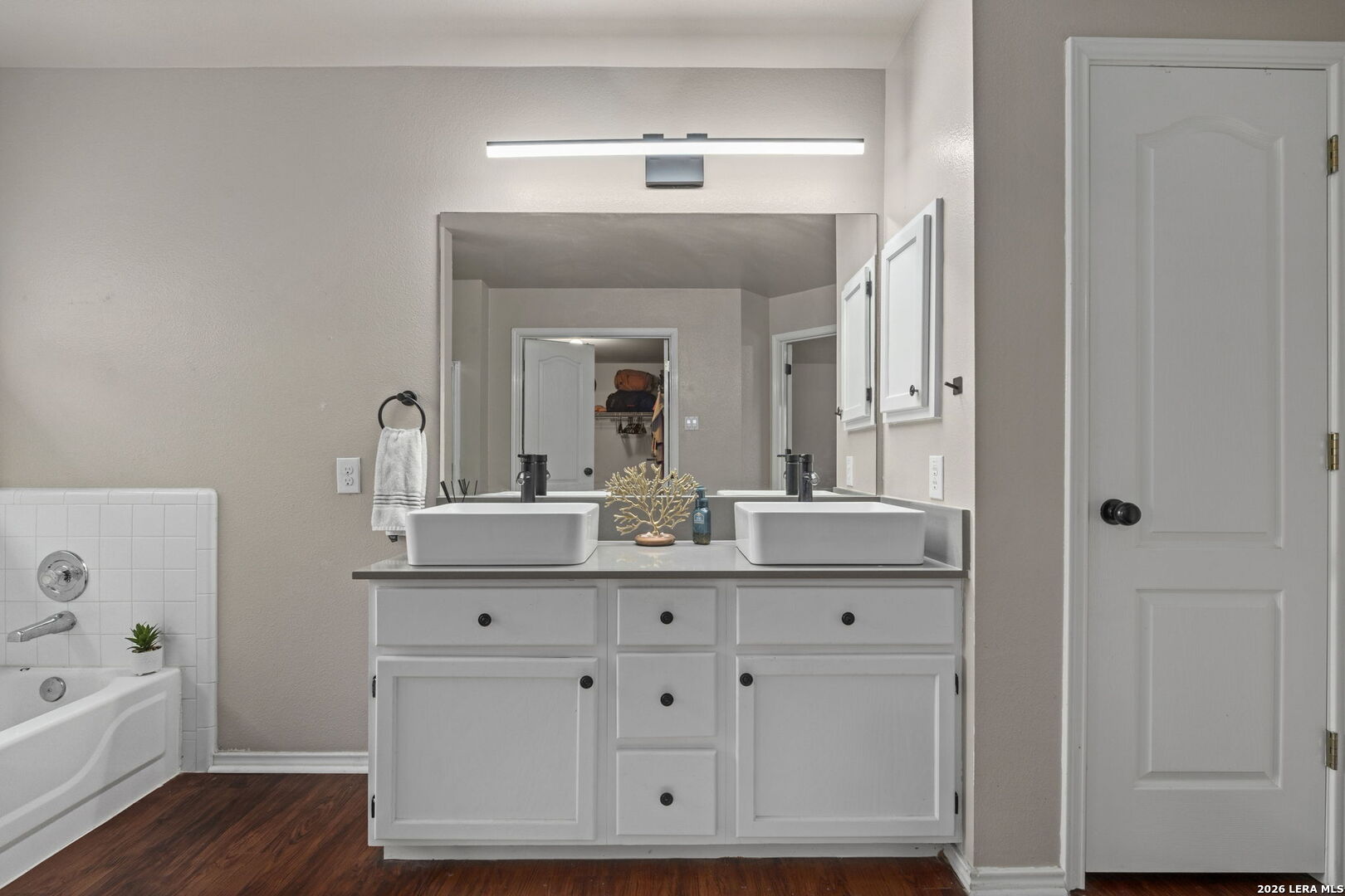 11911 Ghost Bridge Helotes, TX 78023 - Photo 25 of 47 a bathroom with a double vanity sink mirror and bathtub