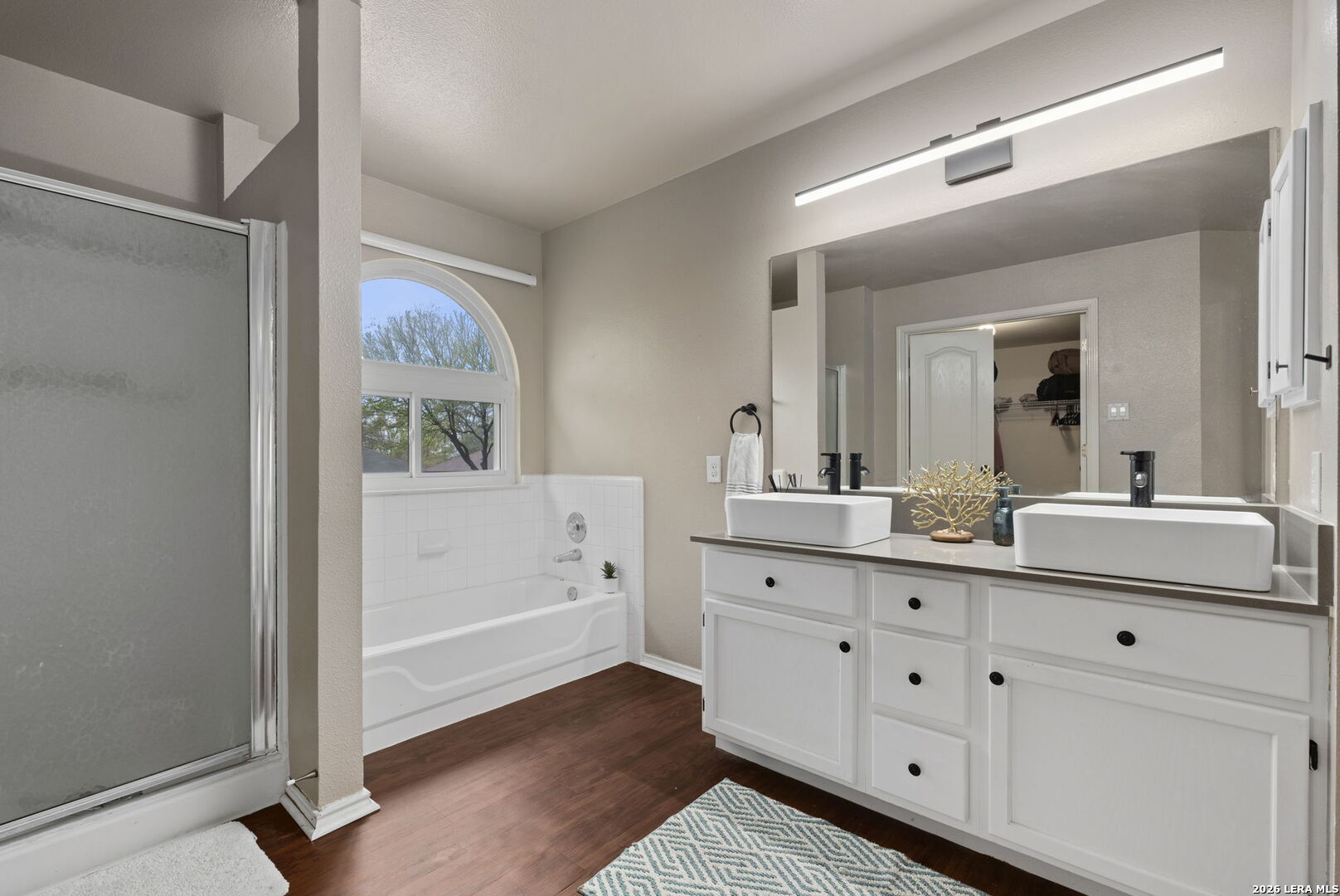 11911 Ghost Bridge Helotes, TX 78023 - Photo 26 of 47 a bathroom with a sink a mirror and a window