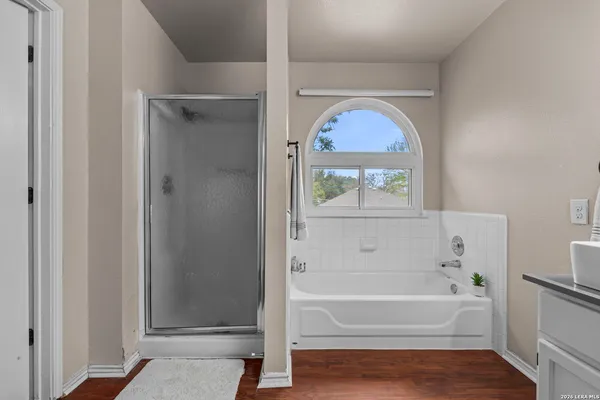 an empty room with windows and ceiling fan