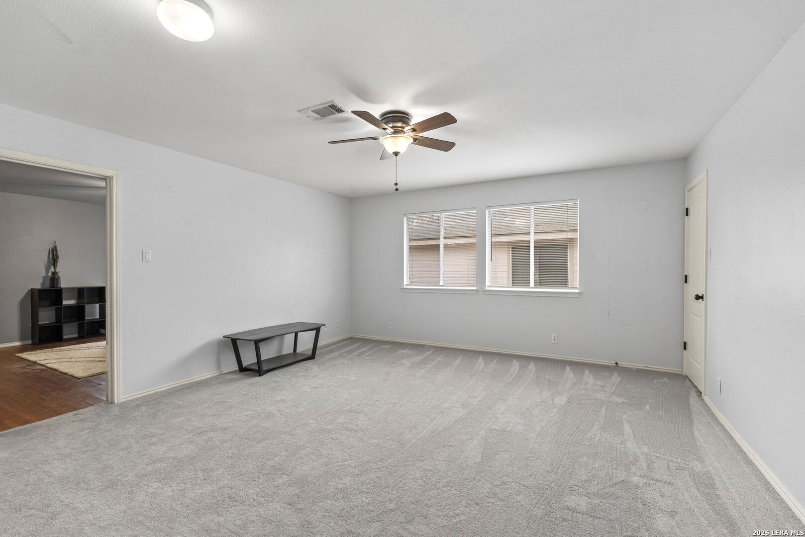 11911 Ghost Bridge Helotes, TX 78023 - Photo 29 of 47 an empty room with windows and ceiling fan