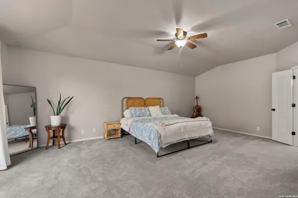 a bedroom with a bed and a ceiling fan