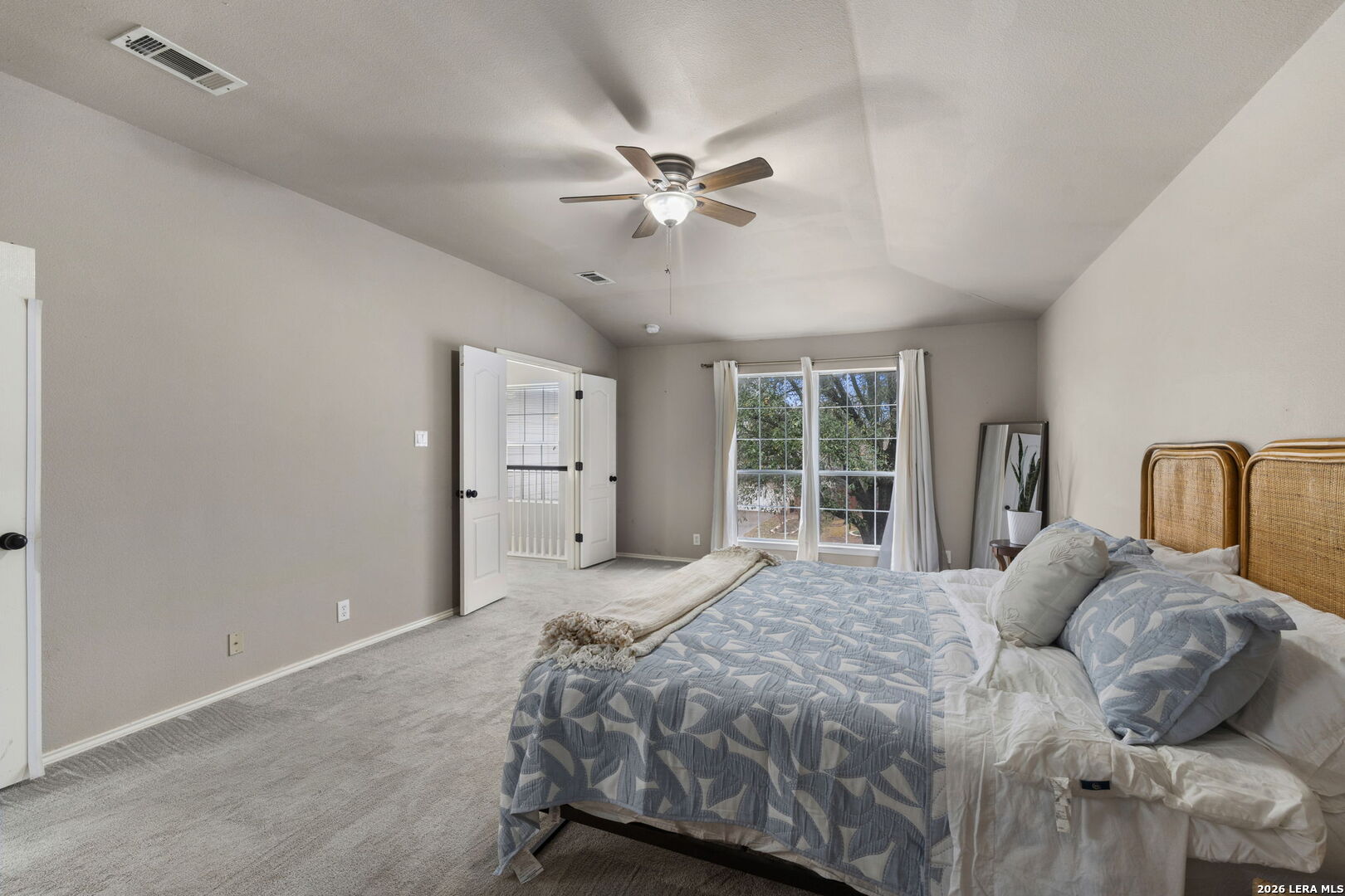11911 Ghost Bridge Helotes, TX 78023 - Photo 32 of 47 a bedroom with a bed and a large window