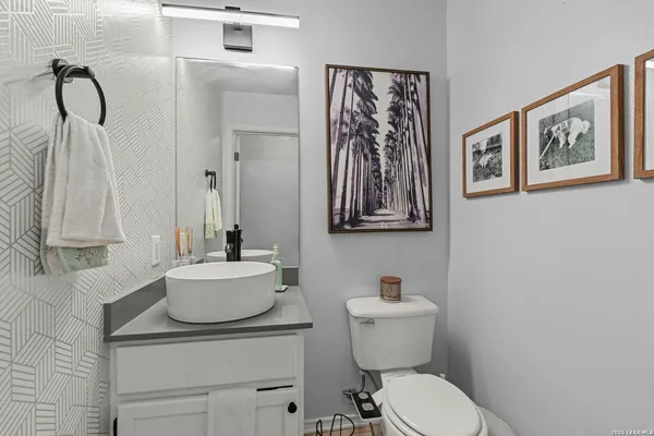 a backyard of a house with barbeque oven table and chairs