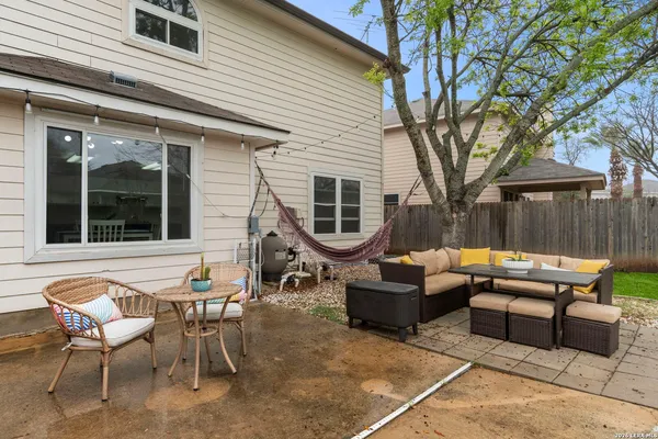 a view of backyard with swimming pool and outdoor seating