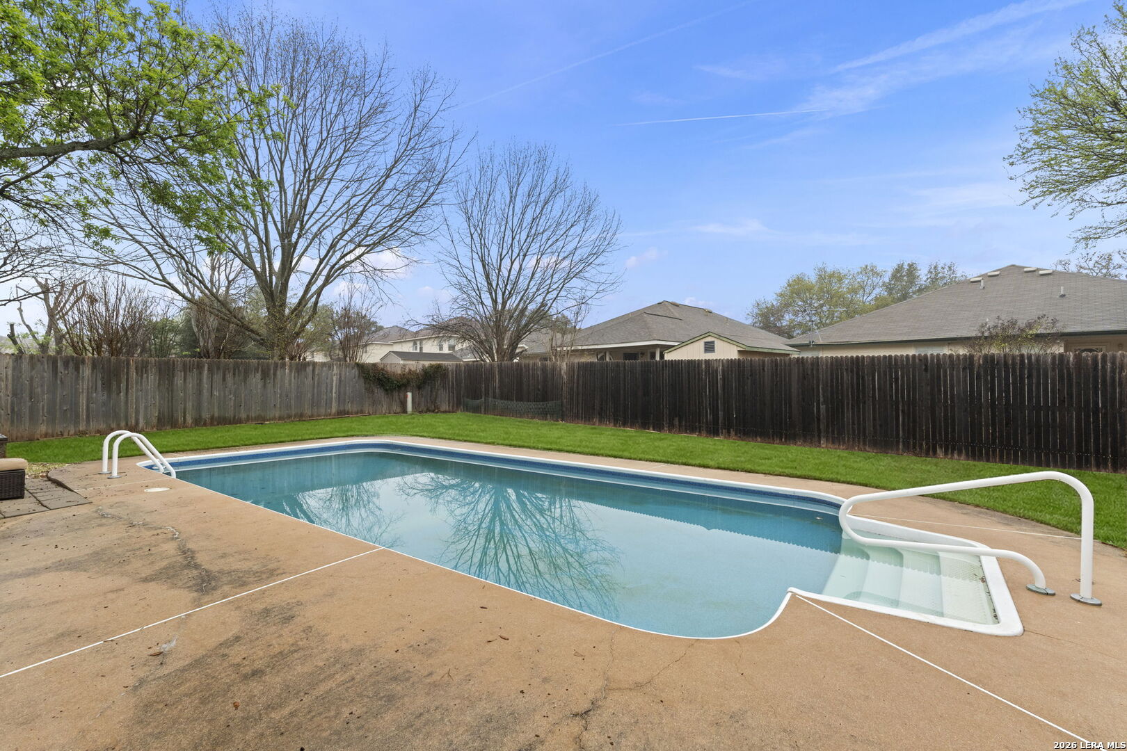 11911 Ghost Bridge Helotes, TX 78023 - Photo 45 of 47 a view of a swimming pool with a yard