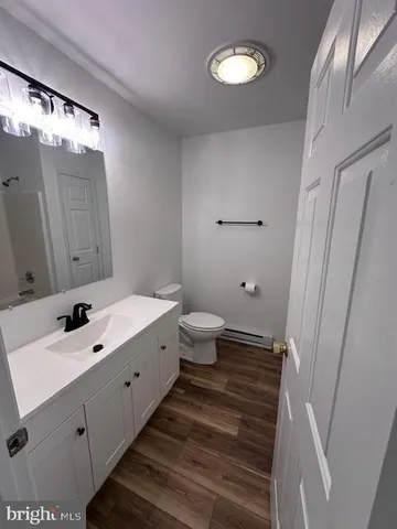 a bathroom with a double vanity sink toilet and a mirror