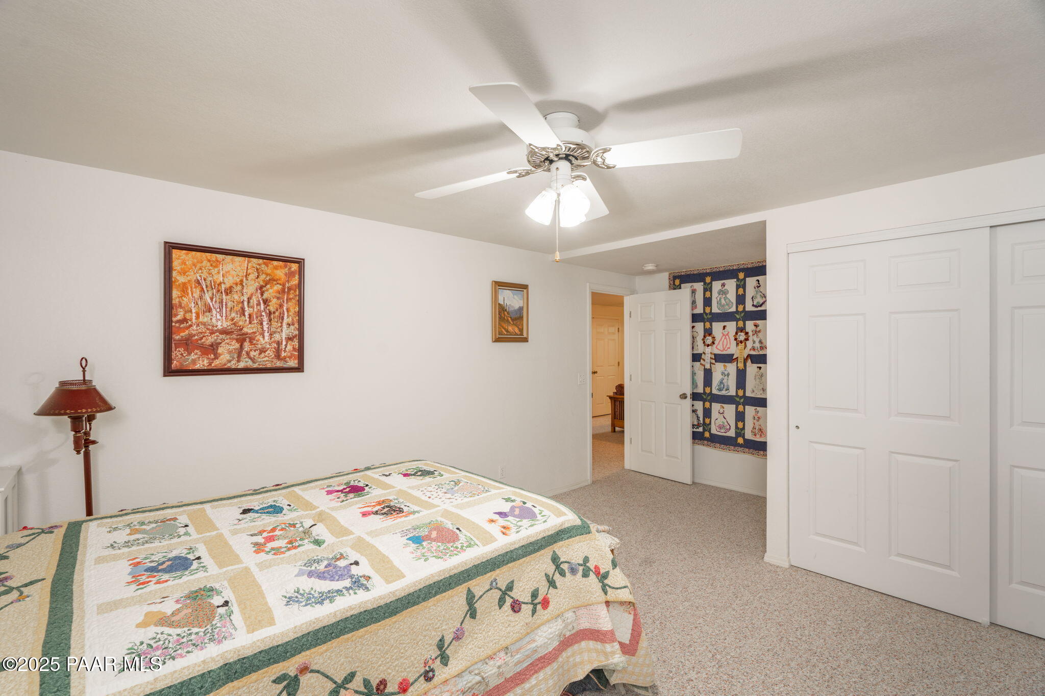 11452 East Turquoise Circle Dewey, AZ 86327 - Photo 26 of 68 a bedroom with a bed and a chandelier