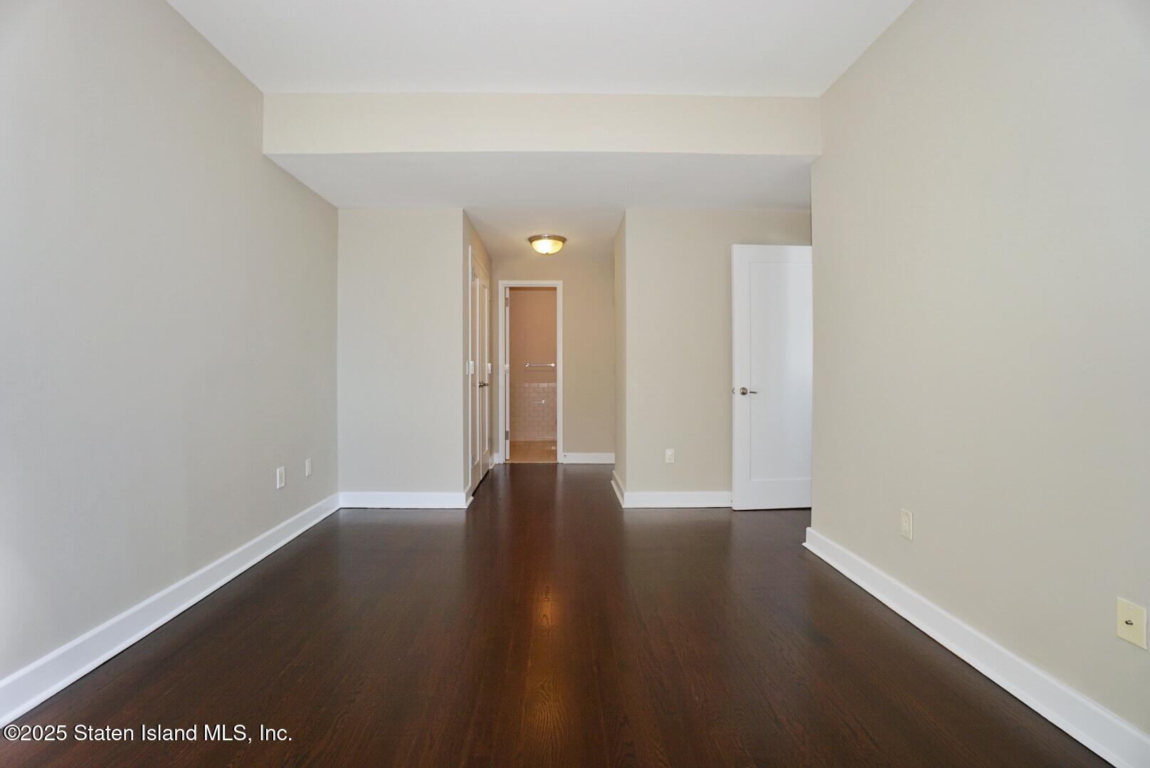 90 Bay Street Landing, Unit 4B Staten Island, NY 10301 - Photo 14 of 42 a view of an empty room with wooden floor