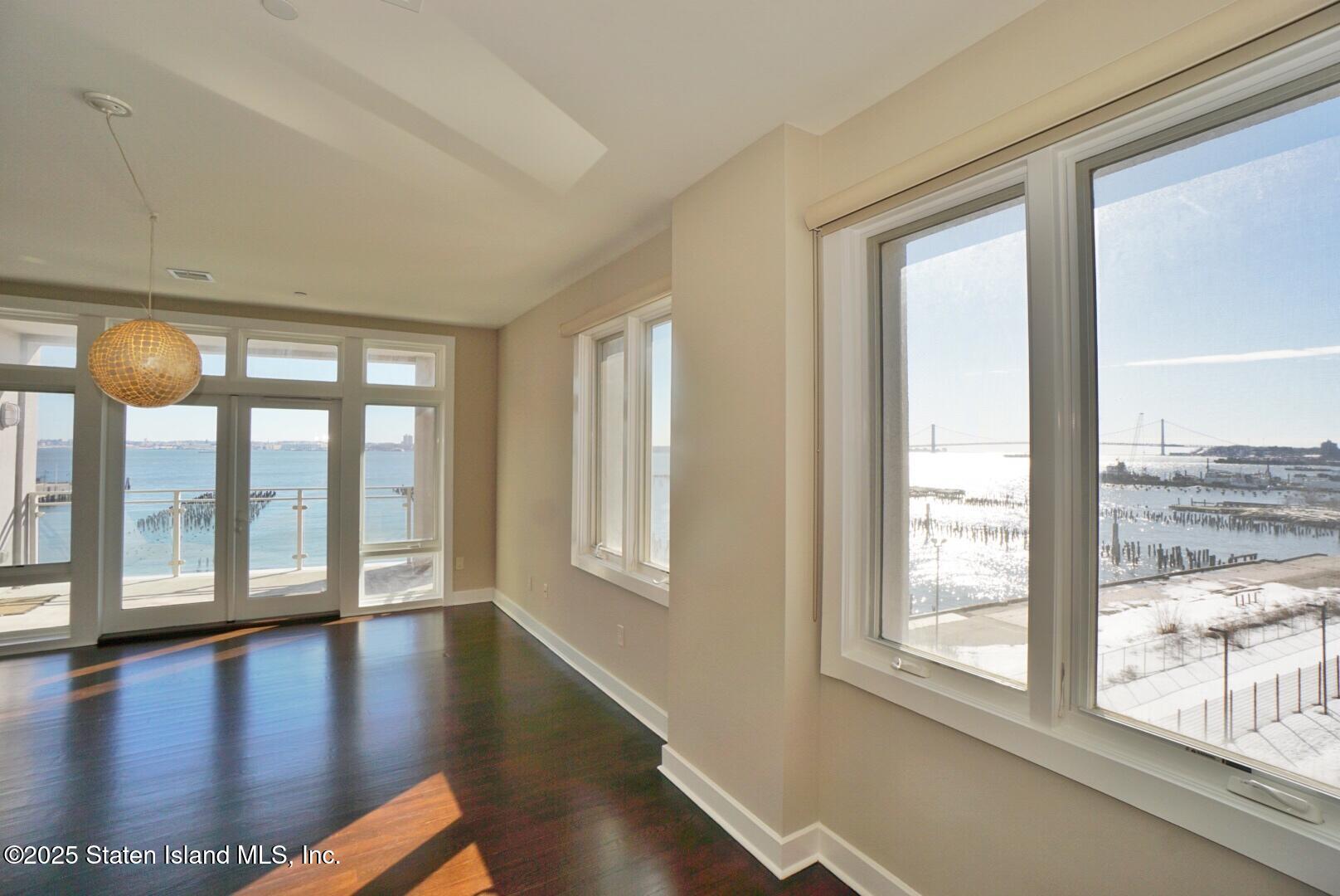90 Bay Street Landing, Unit 4B Staten Island, NY 10301 - Photo 22 of 42 a view of an entryway with wooden floor and door