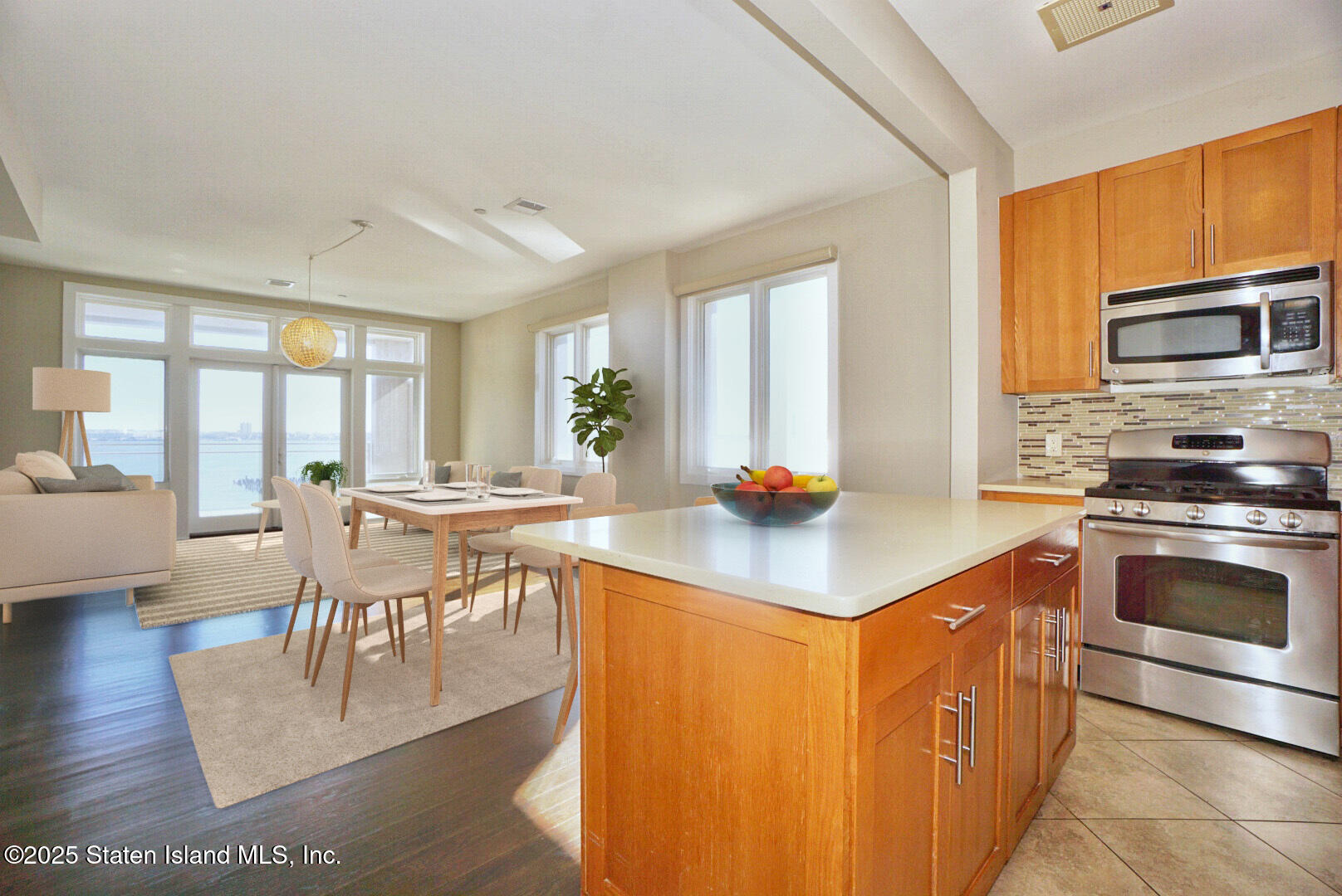 90 Bay Street Landing, Unit 4B Staten Island, NY 10301 - Photo 28 of 42 a kitchen with stainless steel appliances granite countertop a stove top oven a sink dishwasher a dining table and chairs with wooden floor