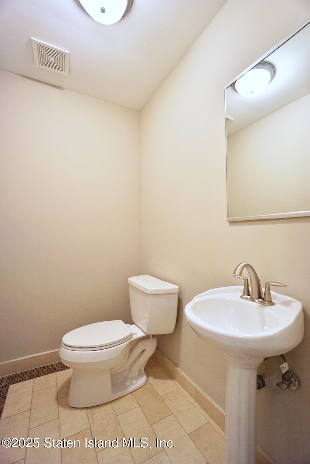 90 Bay Street Landing, Unit 4B Staten Island, NY 10301 - Photo 32 of 42 a bathroom with a sink and a toilet