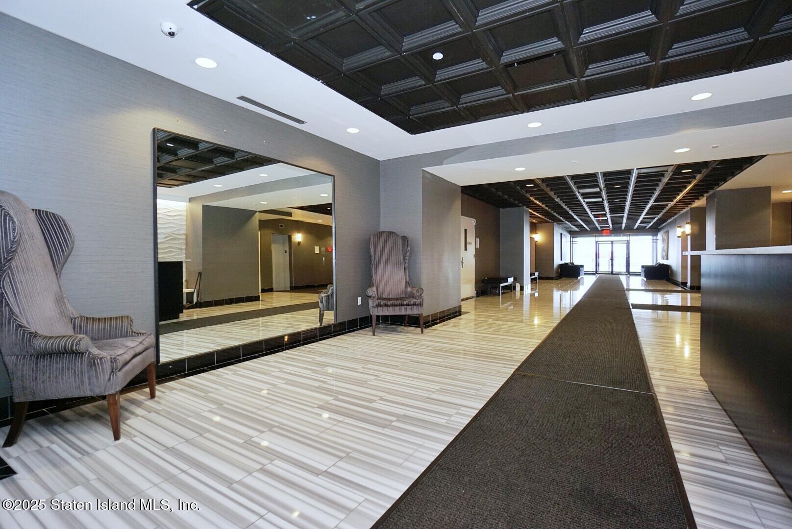 90 Bay Street Landing, Unit 4B Staten Island, NY 10301 - Photo 37 of 42 a lobby with furniture and a rug