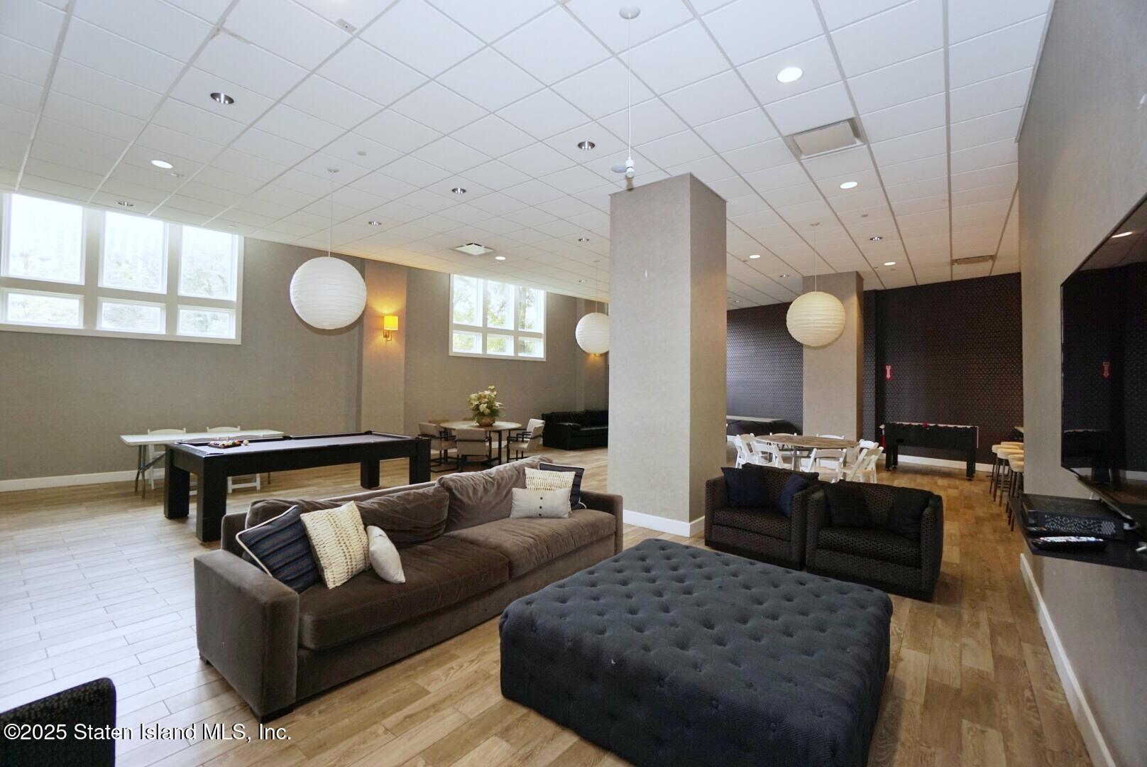 90 Bay Street Landing, Unit 4B Staten Island, NY 10301 - Photo 38 of 42 a living room with furniture and a flat screen tv