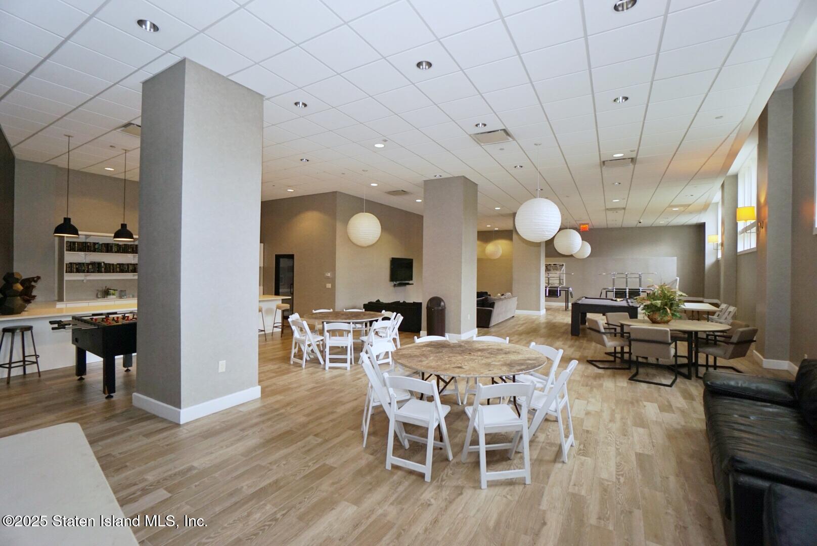 90 Bay Street Landing, Unit 4B Staten Island, NY 10301 - Photo 39 of 42 a view of a dining room with furniture and wooden floor