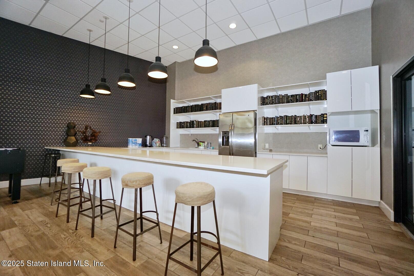 90 Bay Street Landing, Unit 4B Staten Island, NY 10301 - Photo 41 of 42 a kitchen with stainless steel appliances a refrigerator and microwave