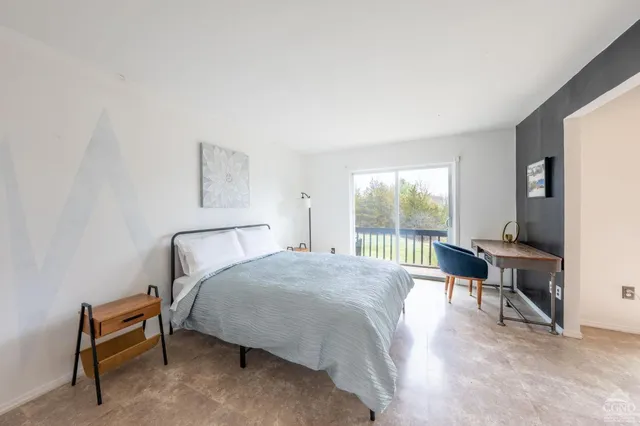 a bedroom with a bed and a table in it