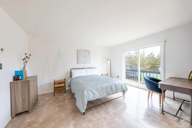 a bedroom with furniture and window