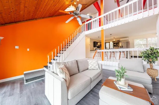 a view of living room and kitchen with furniture and wooden floor