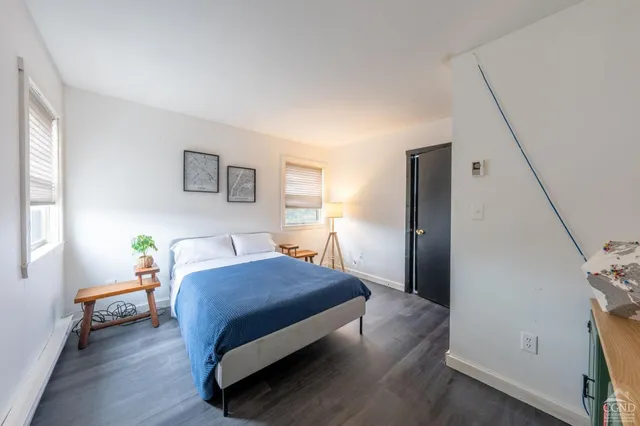 a bedroom with a bed chair and a window