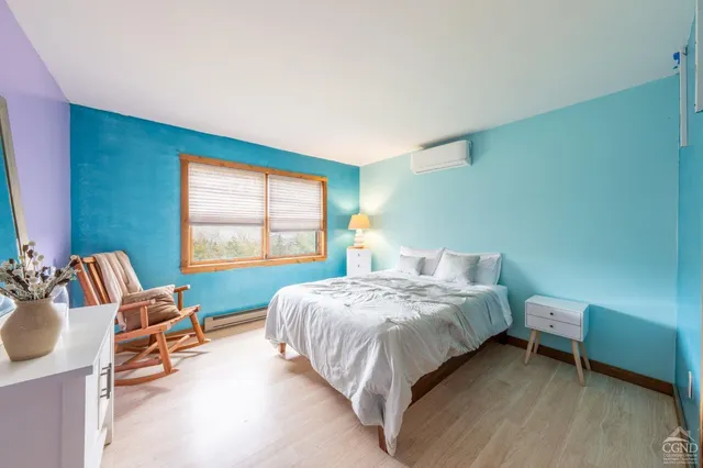 a spacious bedroom with a bed and a lamp