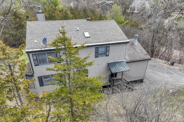 a aerial view of a house with table and chairs in patio