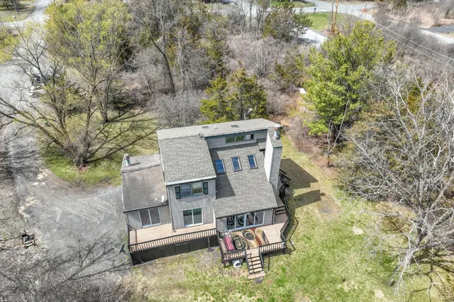 an aerial view of a house with yard and outdoor seating