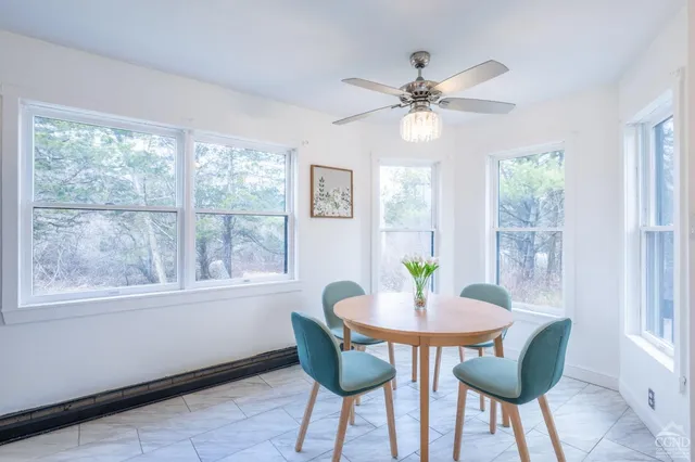 a dining room with furniture a chandelier and a window