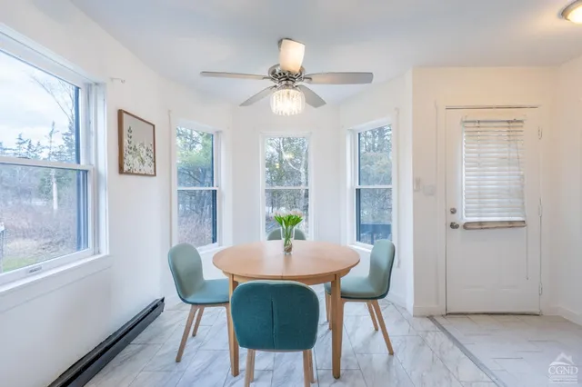 a dining room with furniture and window