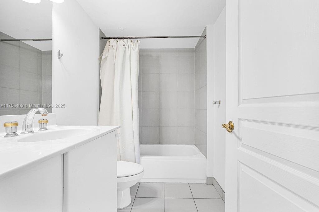 8925 Collins Avenue, Unit 2E Surfside, FL 33154 - Photo 16 of 46 a bathroom with a sink a toilet and shower