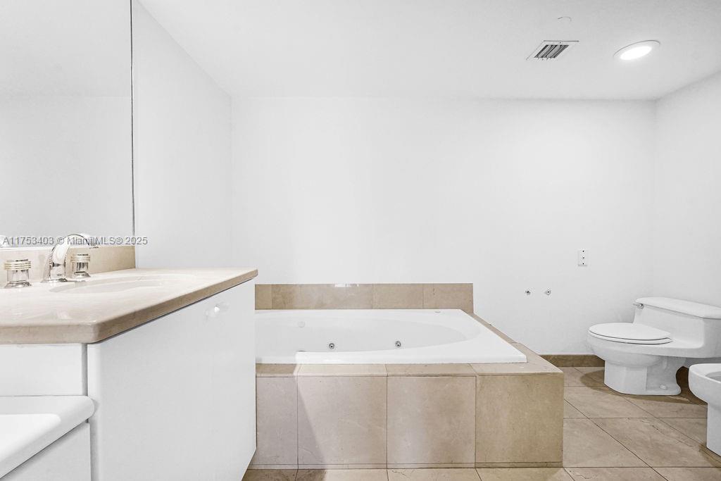 8925 Collins Avenue, Unit 2E Surfside, FL 33154 - Photo 22 of 46 a bathroom with a sink and a toilet