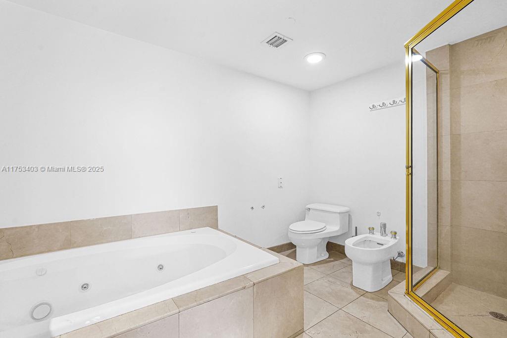 8925 Collins Avenue, Unit 2E Surfside, FL 33154 - Photo 23 of 46 a bathroom with a toilet and a bathtub